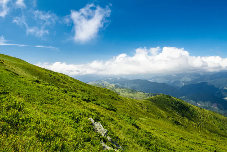 Green Himalayan slopes under a blue sky near Khyarkuli, Mussoorie