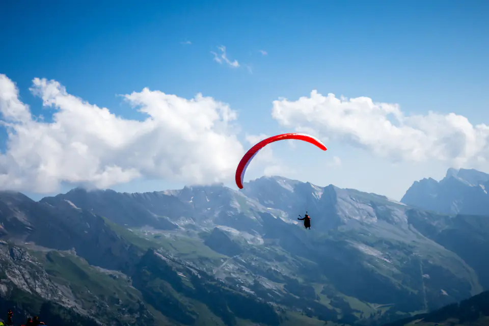 A paraglider above a mountain valley
