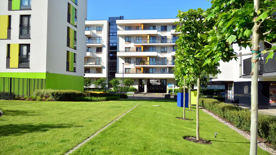 Apartment buildings around a landscaped lawn